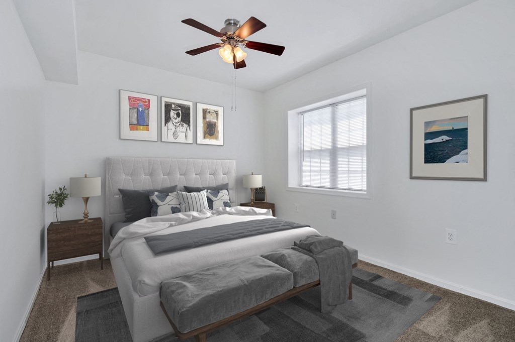 a bedroom with a large bed and a ceiling fan