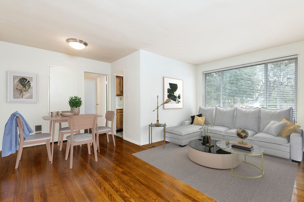 a living room with a couch and a table and a window