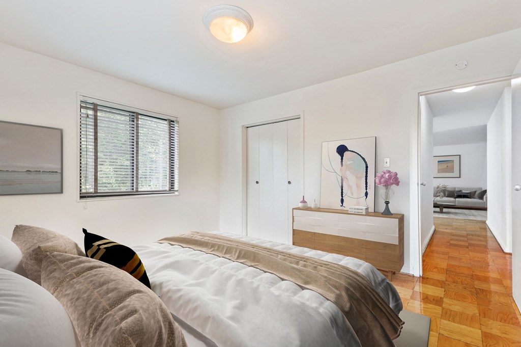 a bedroom with a bed and a dresser and a window