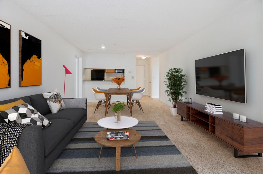 a living room with a couch and a table and a television