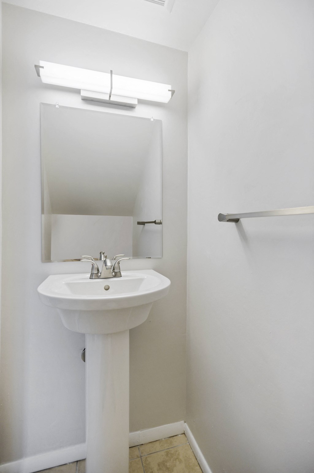 a small bathroom with a sink and a mirror