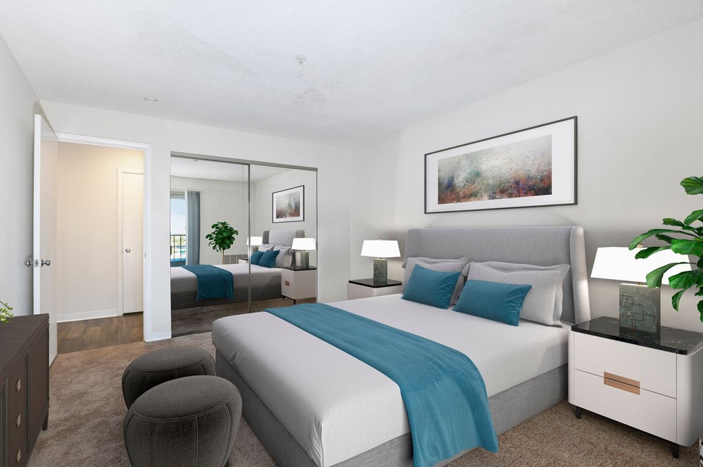 a bedroom with a white bed and a blue blanket