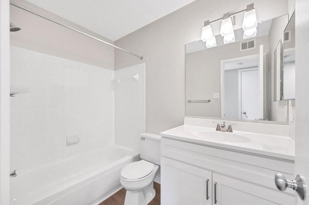 a white bathroom with a sink and a toilet