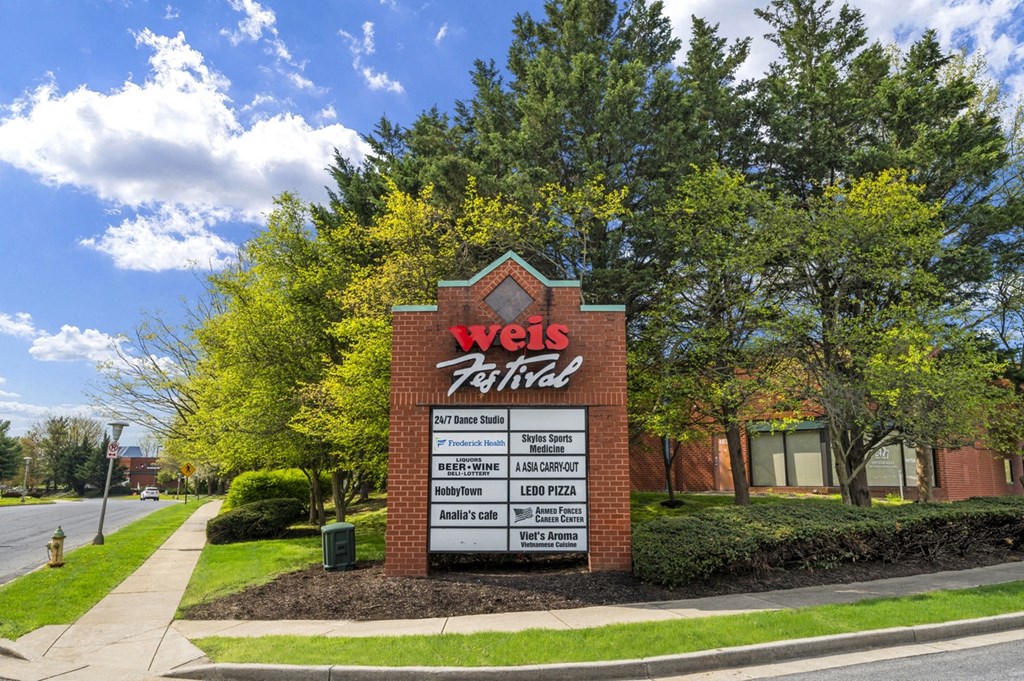 the sign in front of a brick building with trees