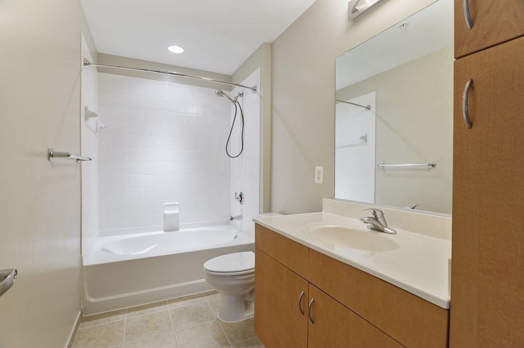 a bathroom with a sink and a shower and a toilet