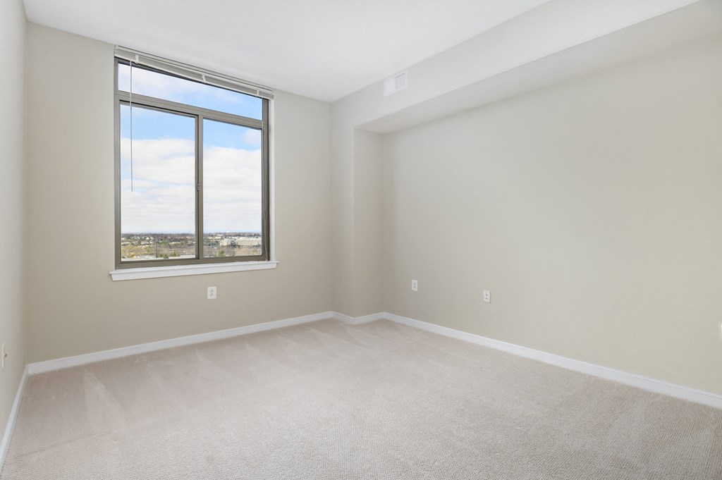 an empty living room with a large window