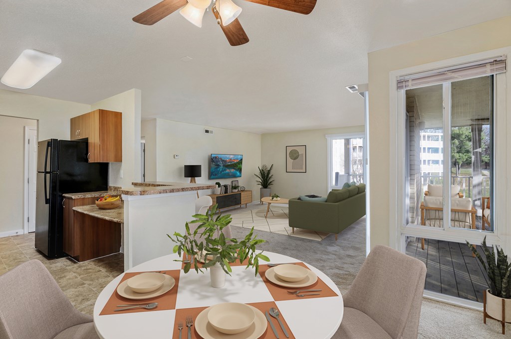 A dining room with a table set for a meal.