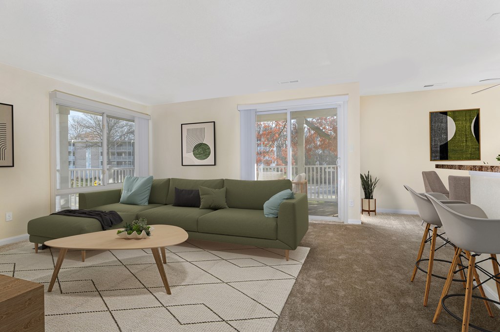 A living room with a green couch and a coffee table.