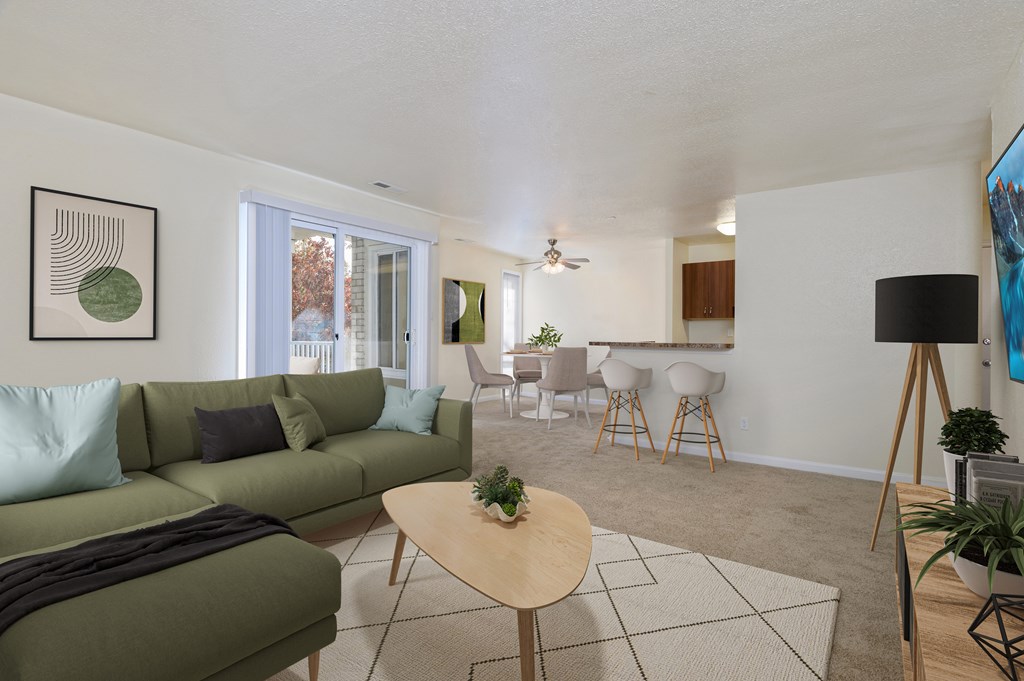 A living room with a green couch and a wooden coffee table.