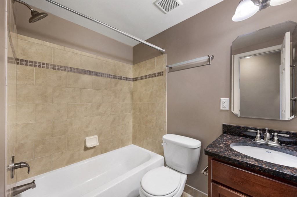 a bathroom with a sink toilet and a bath tub