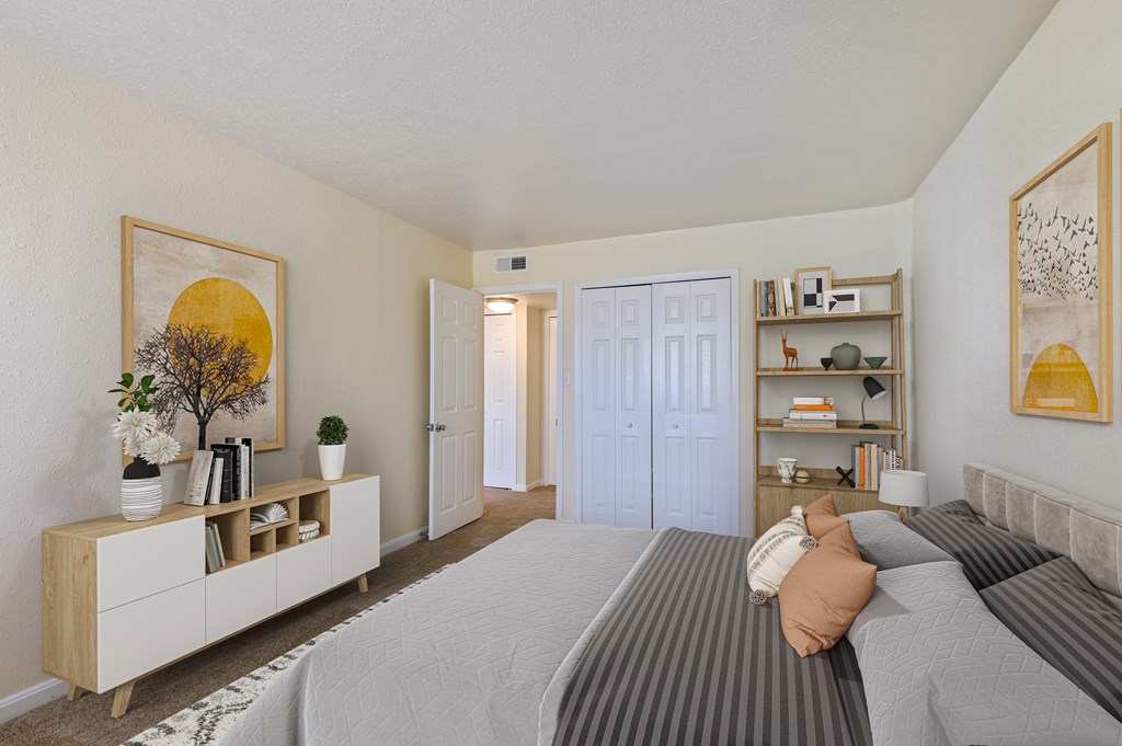 A bedroom with a bed, dresser, and a painting on the wall.