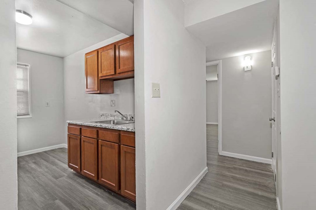 two views of a kitchen and a room with a counter