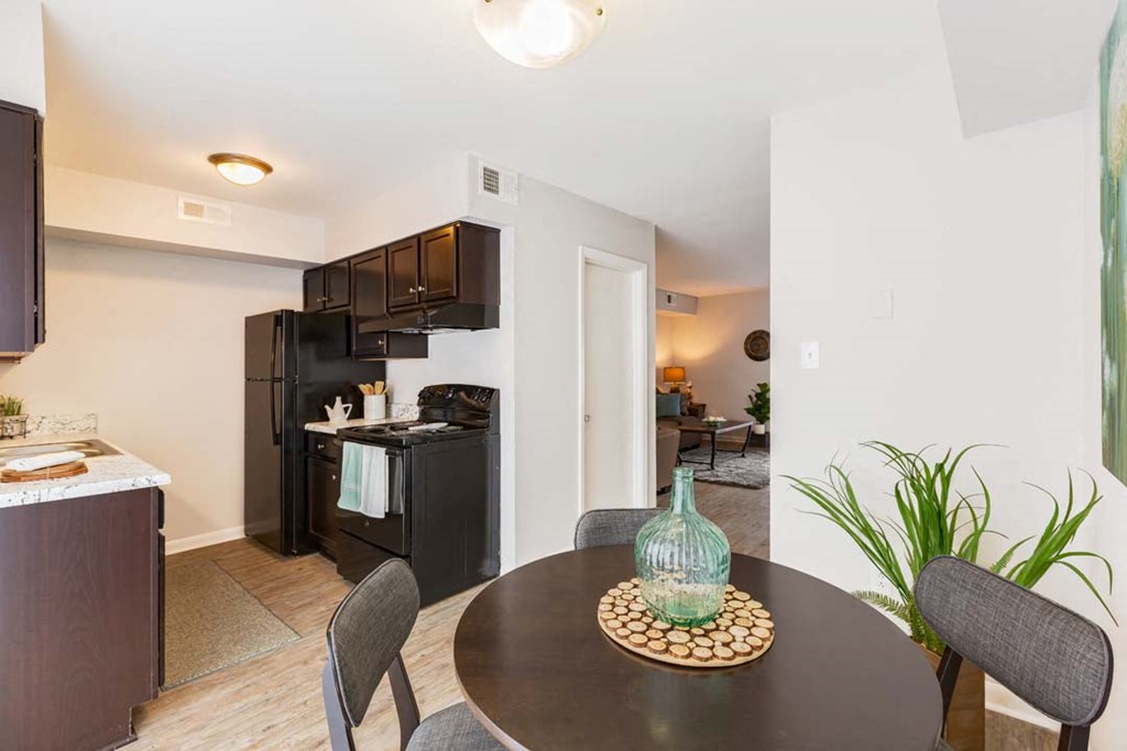 a kitchen and dining room with a table and chairs