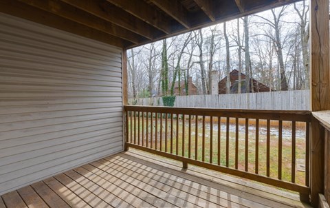 A wooden deck with a sliding door in the background.