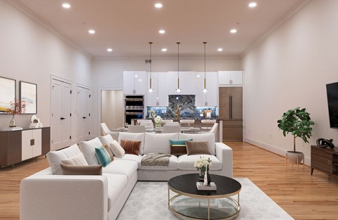 A modern living room with a white sofa and a glass coffee table.