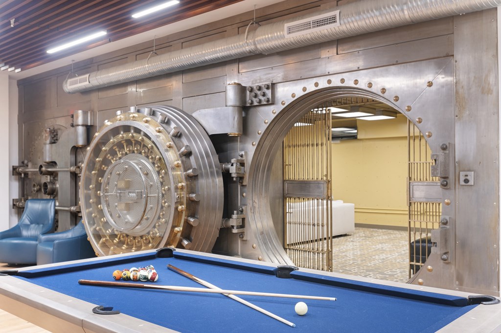 a pool table in front of a mechanical machine