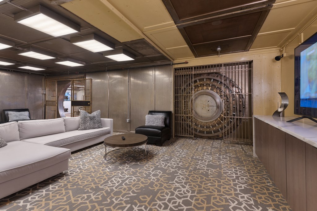 a living room with a white couch and a television