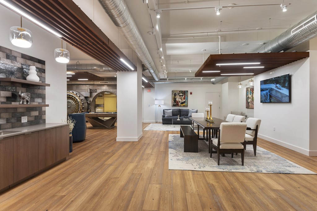 a dining room and living room with a table and chairs