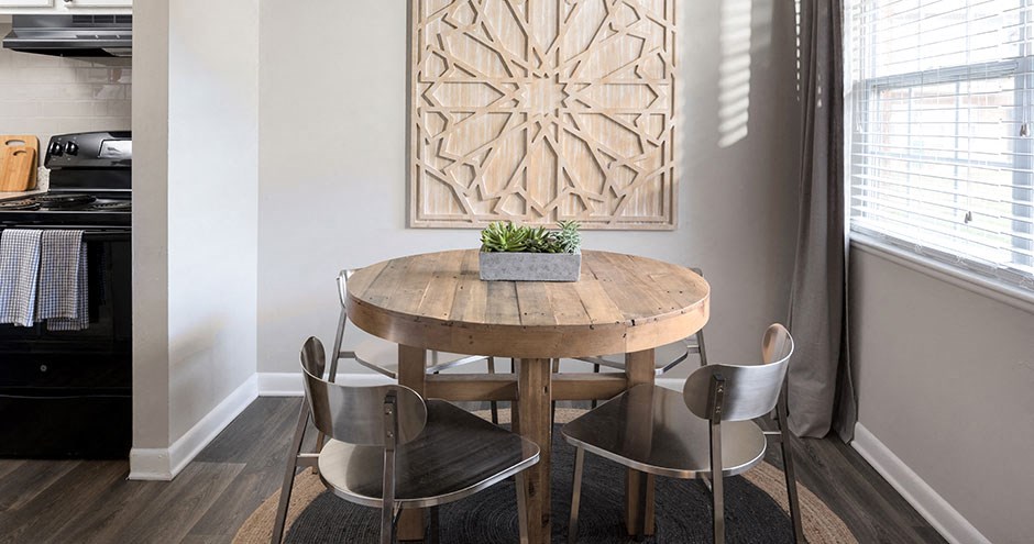 a dining room with a wooden table and chairs