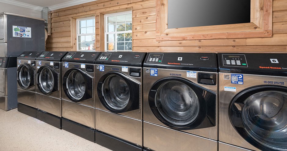a row of washing machines in a laundry room