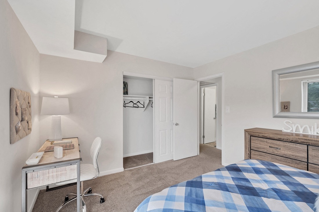 a bedroom with a bed and a desk