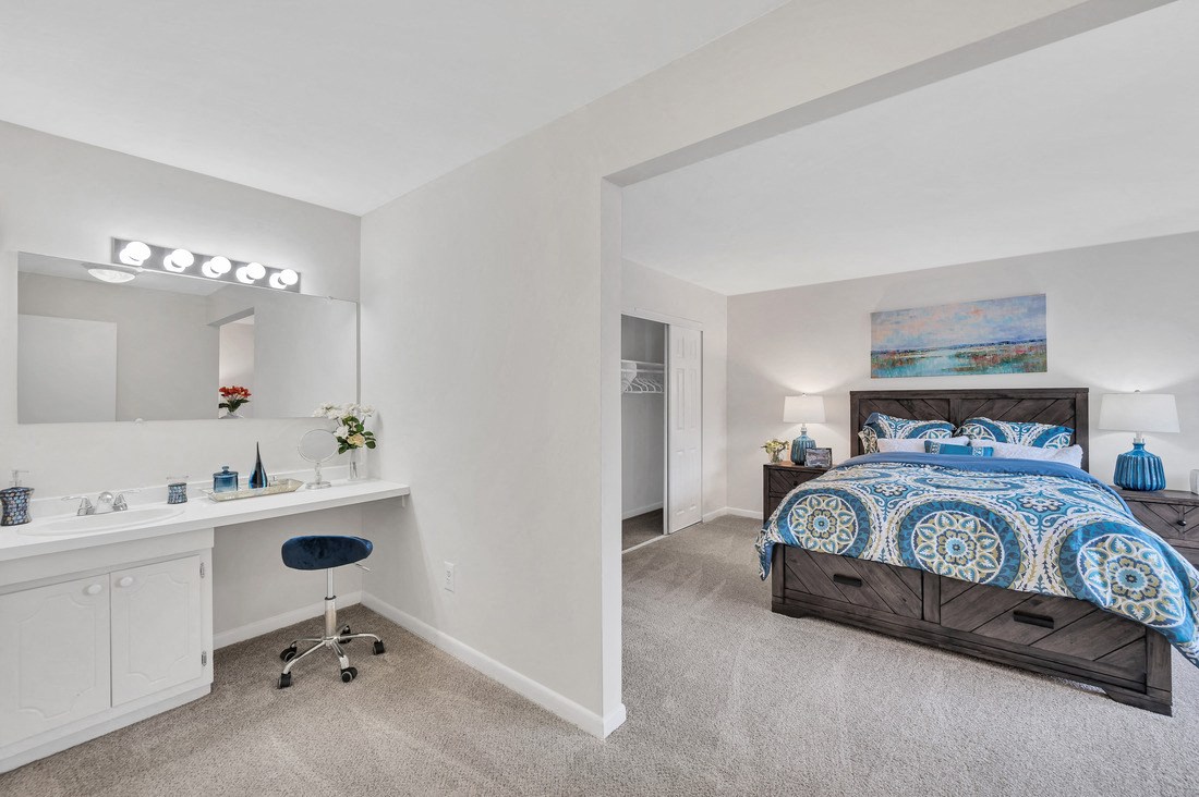 a bedroom with a bed and a desk with a chair