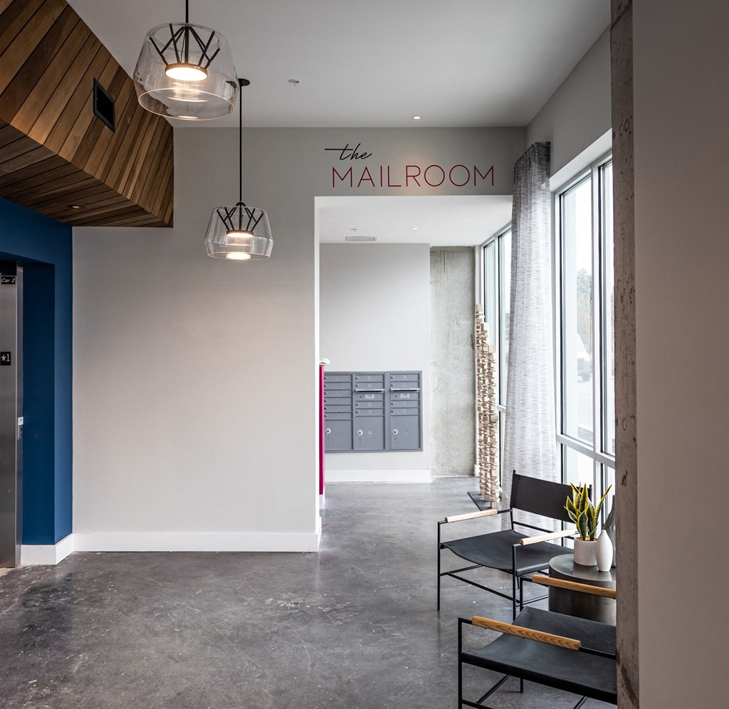 the lobby of the hotel with a seating area and a table and chairs
