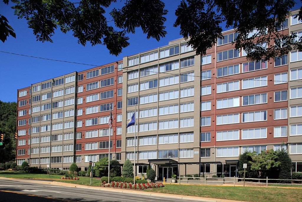 an apartment building on a city street with a flag