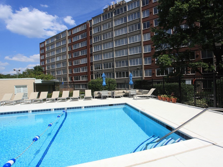 a swimming pool at a hotel in front of a building