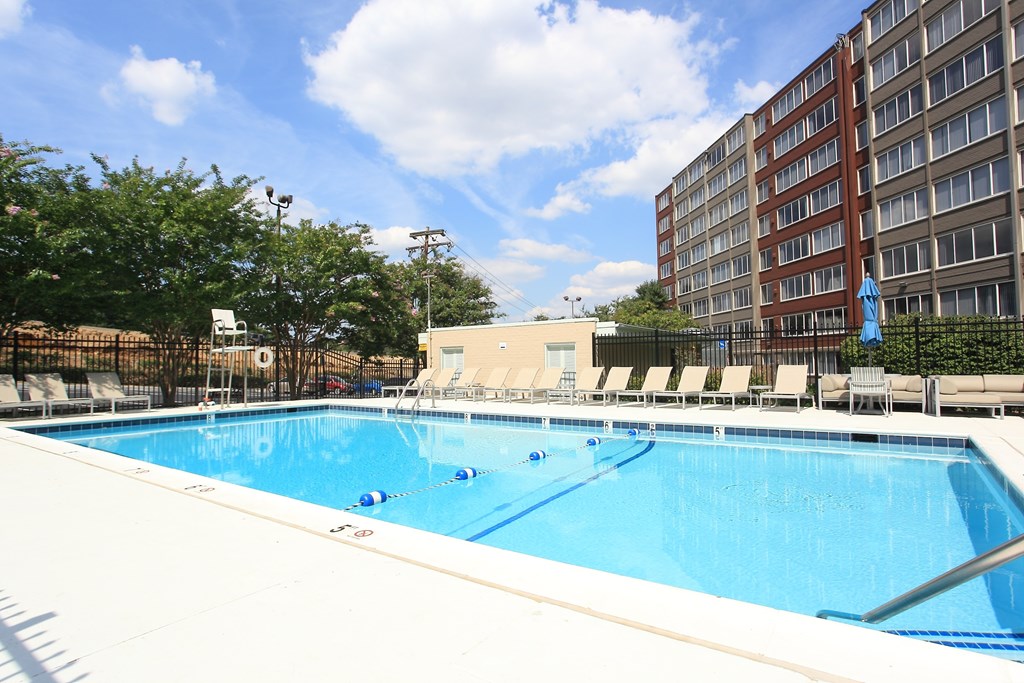 a swimming pool at a hotel in front of a building