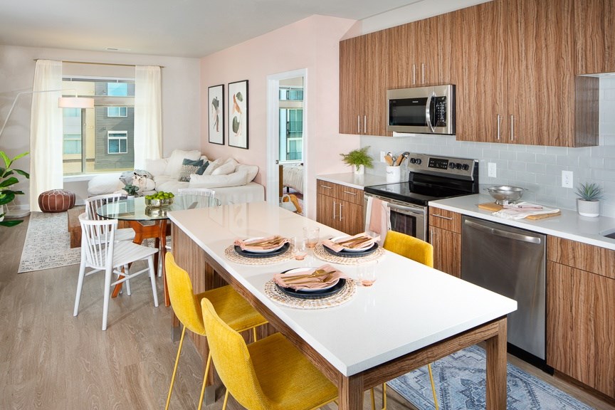A kitchen with a table set for a meal.