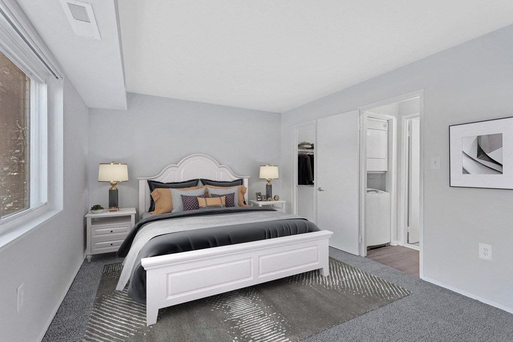 a bedroom with a large bed and a white closet