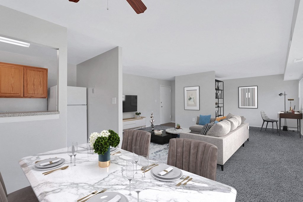 a living room and dining room with a table and chairs