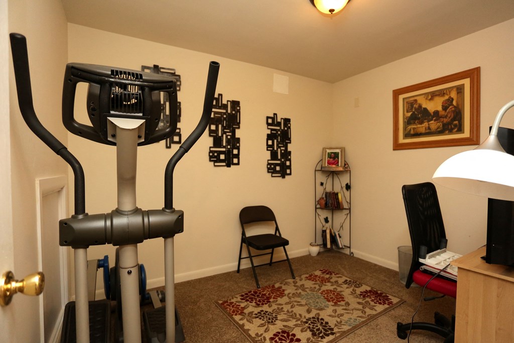 a room with a camera on a tripod in front of a desk and a chair