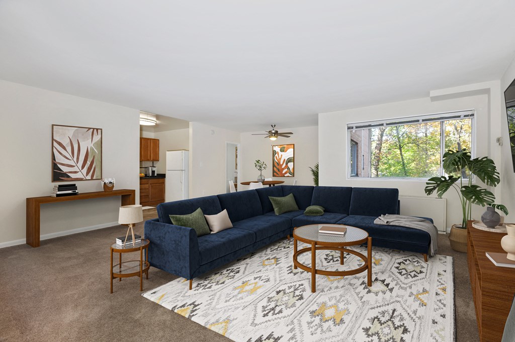 a living room with a blue couch and a rug
