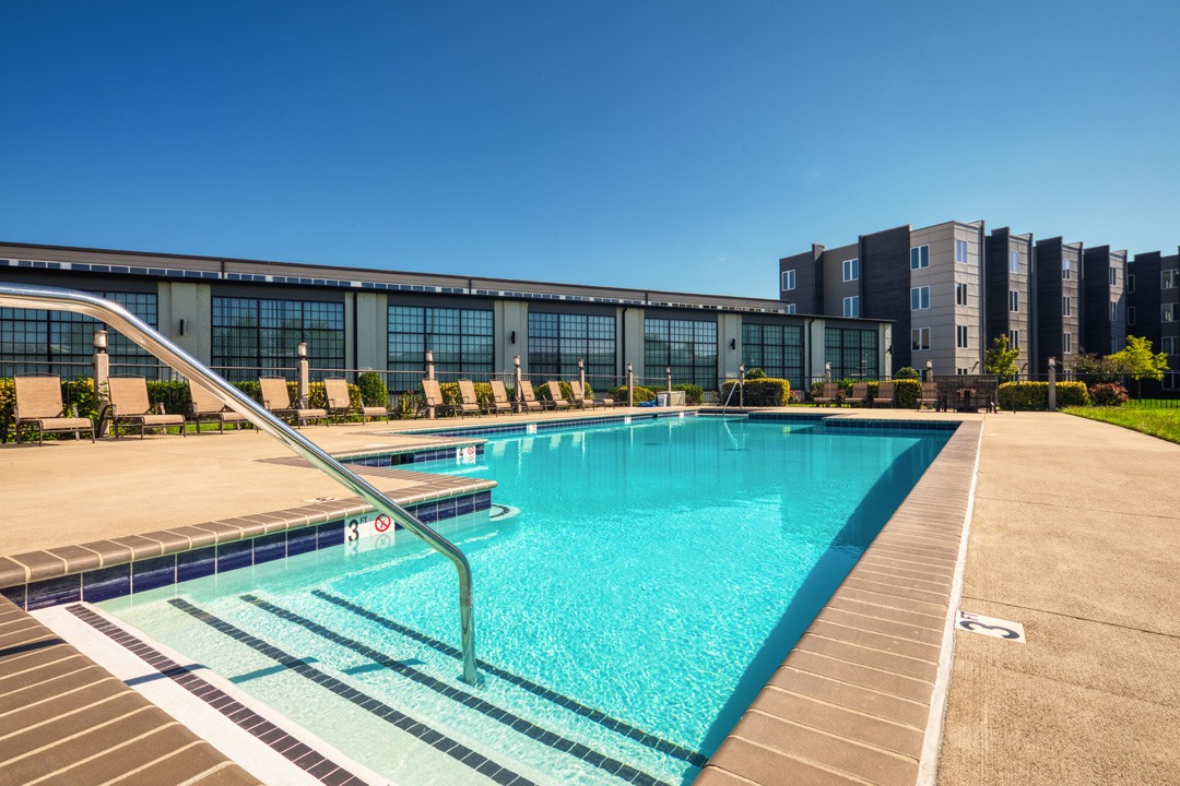 A large swimming pool in front of a building.