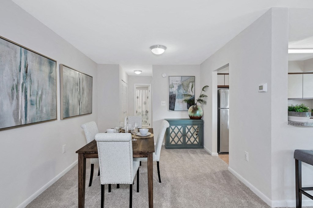 a dining room with a table and chairs