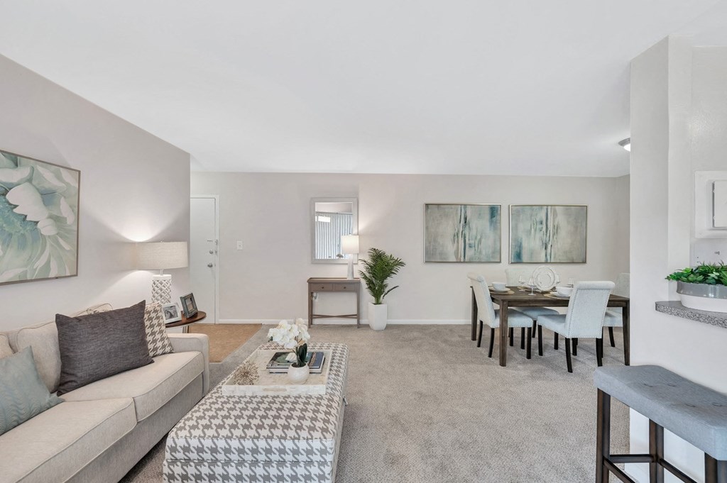 a living room with a couch and a table with chairs