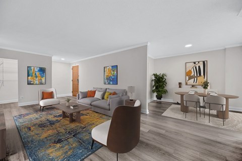 A living room with a brown chair and a blue rug.