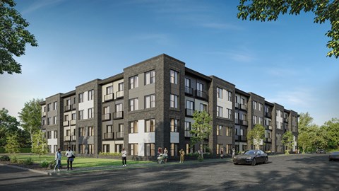A modern apartment complex with a parking lot in front.