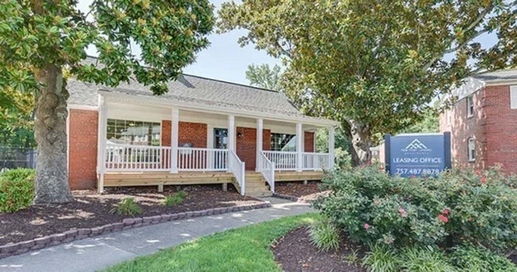 a house with a porch and a sign in front of it