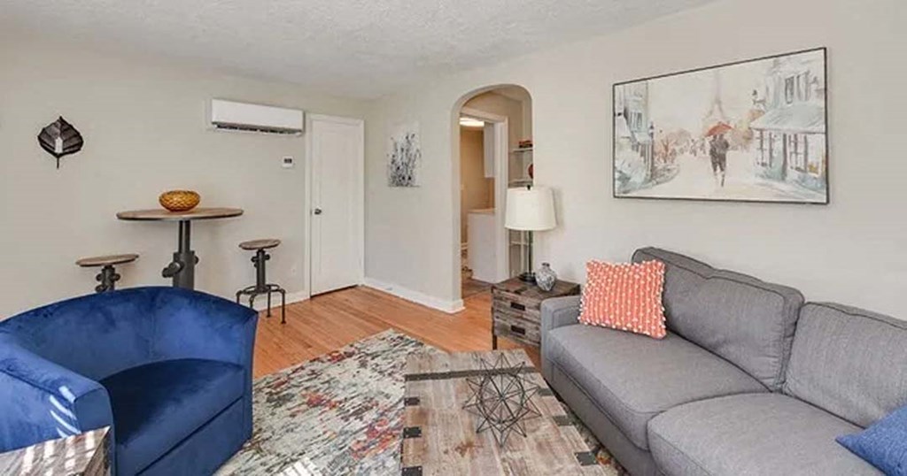 a living room with a blue chair and a couch
