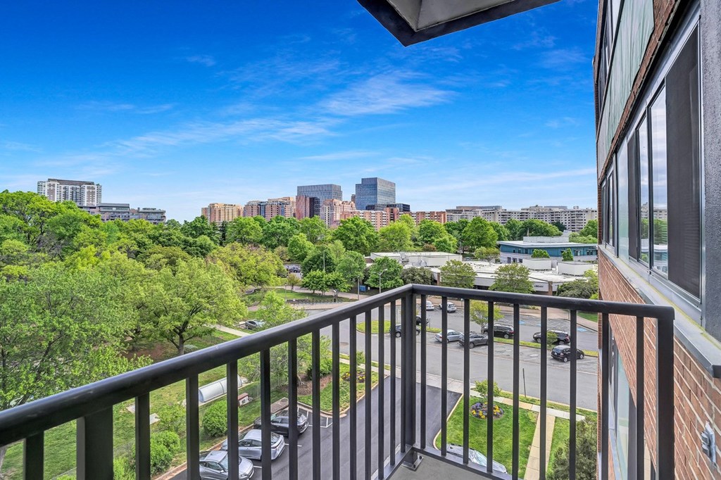 the view of the city from the balcony of an apartment building with a balcony railing