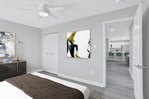 a bedroom with a bed and a ceiling fan