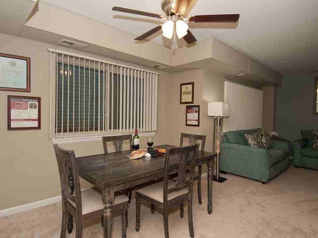 a dining room with a table and chairs and a ceiling fan