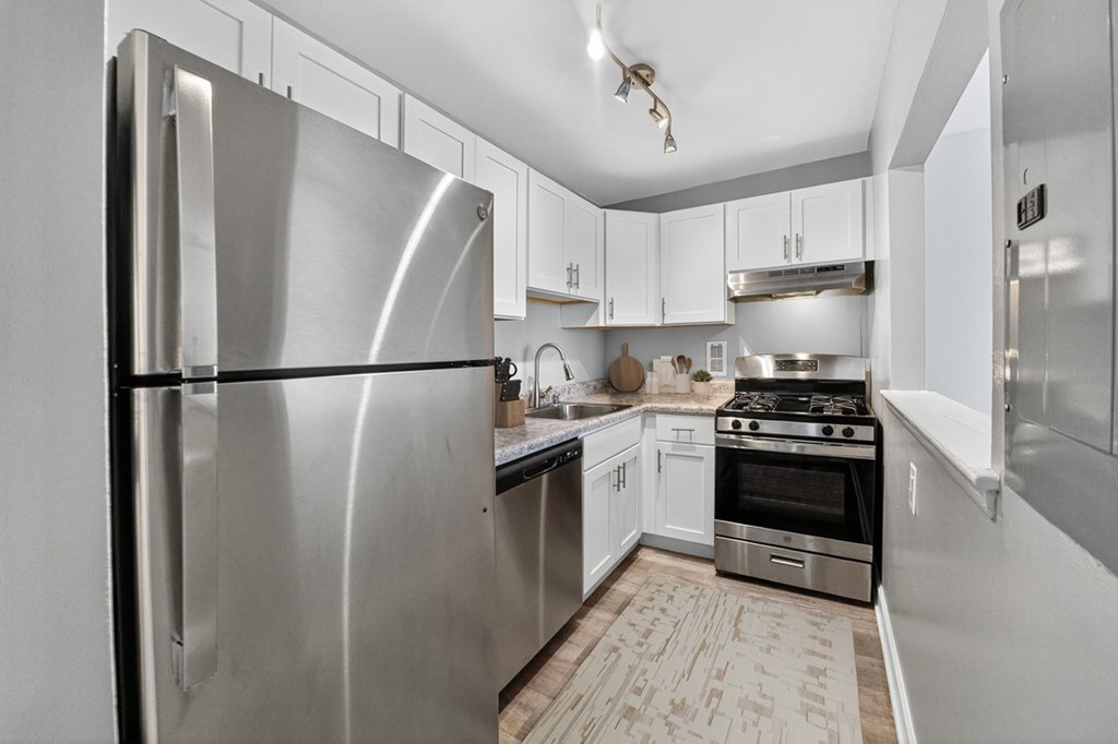 A modern kitchen with a stainless steel refrigerator.