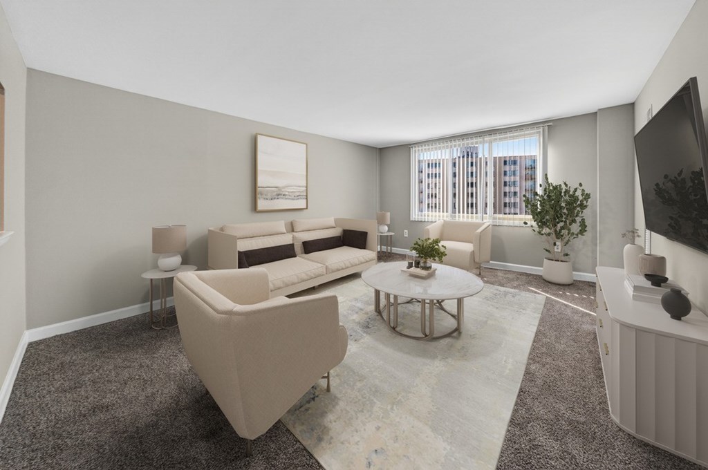 A living room with a large sofa, a small table, and a television.