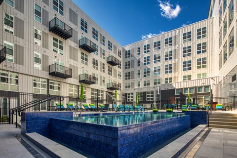 a large pool in front of a large apartment building