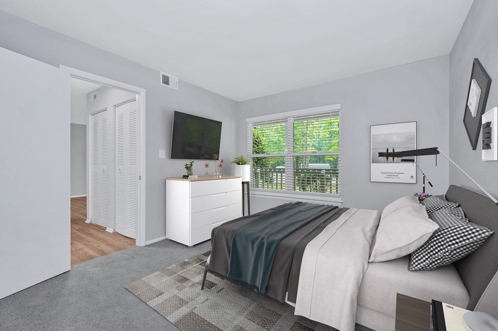 a bedroom with a bed and a tv in a 555 waverly unit