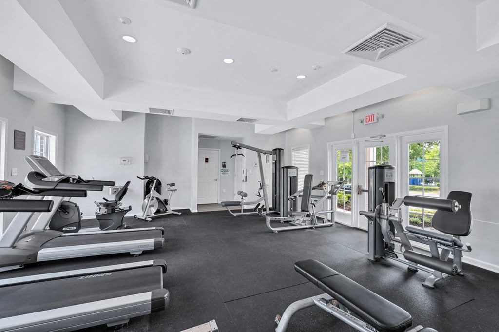 the gym is equipped with cardio equipment and free weights